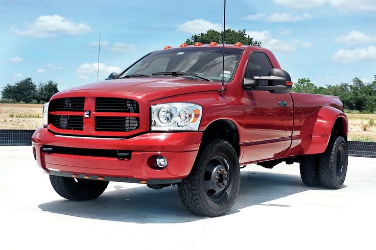 a red dodge ram truck parked in a parking lot