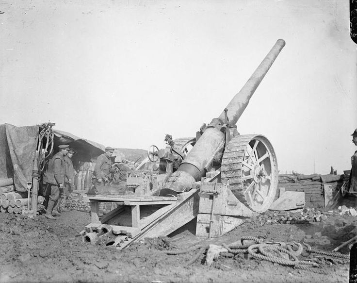 an old black and white photo of men standing next to a cannon