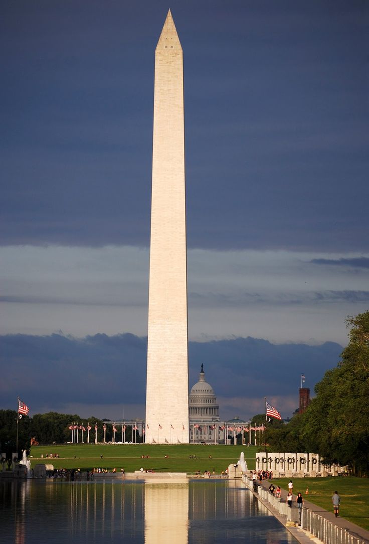 the washington monument and reflecting pool in front of it