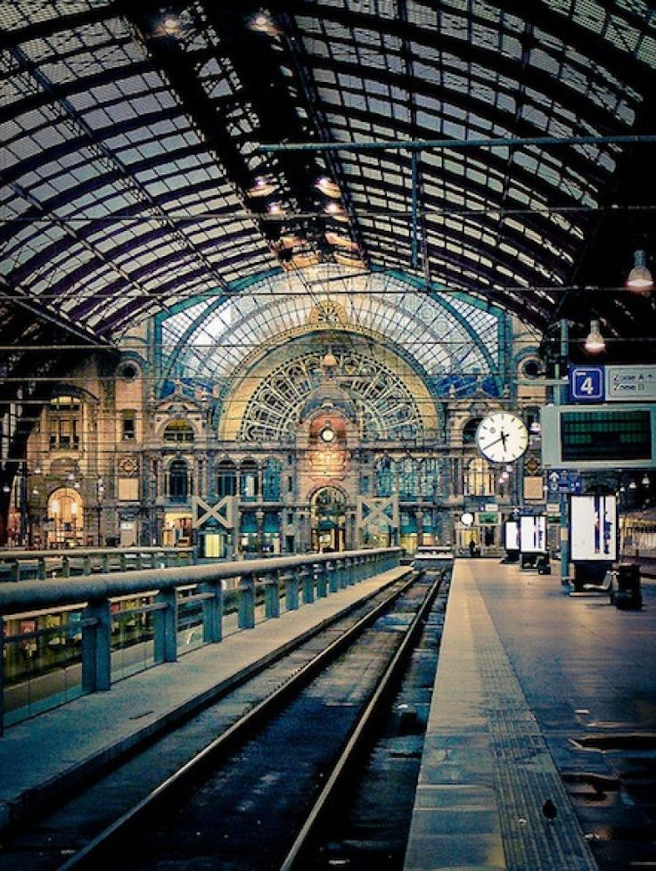 an empty train station with many trains on the tracks