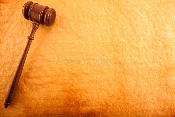 a wooden judge's gavel on top of a brown paper background stock photos