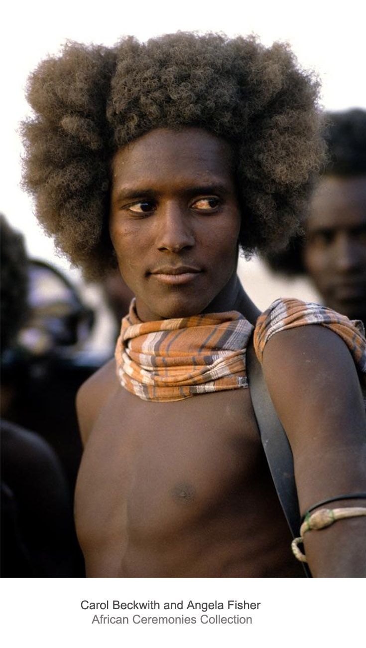 a man with an afro wearing a scarf around his neck