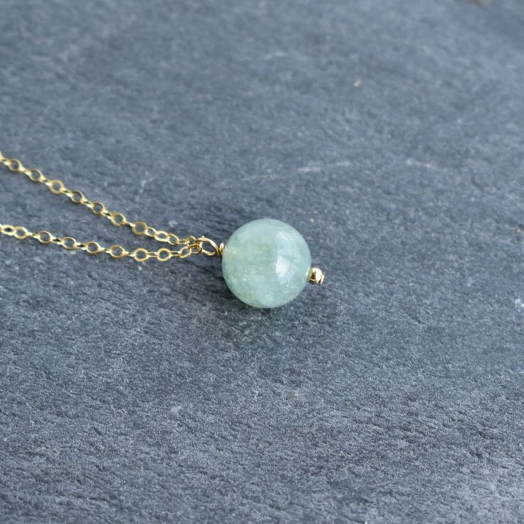 Single 10mm Jade bead hangs from your choice of sterling silver or gold filled chain. This chain will not tarnish, and can even get wet! Jade has many benefits! - A stone of good luck and fortune - Soothing and calming stone that promotes harmony and balance in friendships, family and work. - Promotes confidence and self sufficiency - Releases negative energy and promotes emotional and spiritual healing. Everyday Aventurine Jewelry With Natural Stones, Gemstone Beads Charm Necklaces As Gift, Gemstone Bead Charm Necklaces As Gifts, Gift Charm Necklaces With Round Gemstone Beads, Minimalist Round Bead Charm Necklace As Gift, Everyday Round Necklaces With Natural Stones, Natural Stones Round Bead Charm Necklace As Gift, Gift Gemstone Charm Necklaces With Round Beads, Round Beads Natural Stones Charm Necklace As Gift