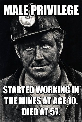 a black and white photo of a man wearing a fireman's hat with a light on his forehead