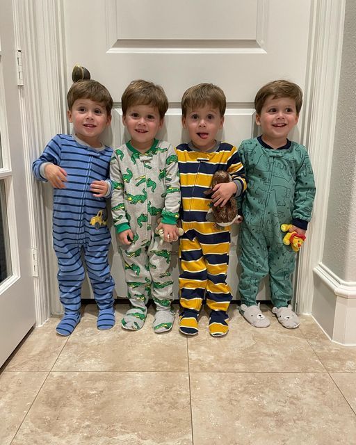 three boys in pajamas standing next to each other on the floor with their hands together