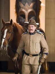 a man in uniform standing next to a horse