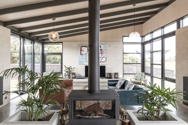 a living room filled with furniture and a fire place in the middle of it's walls