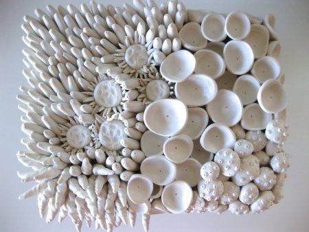 an arrangement of white plates and bowls on a table