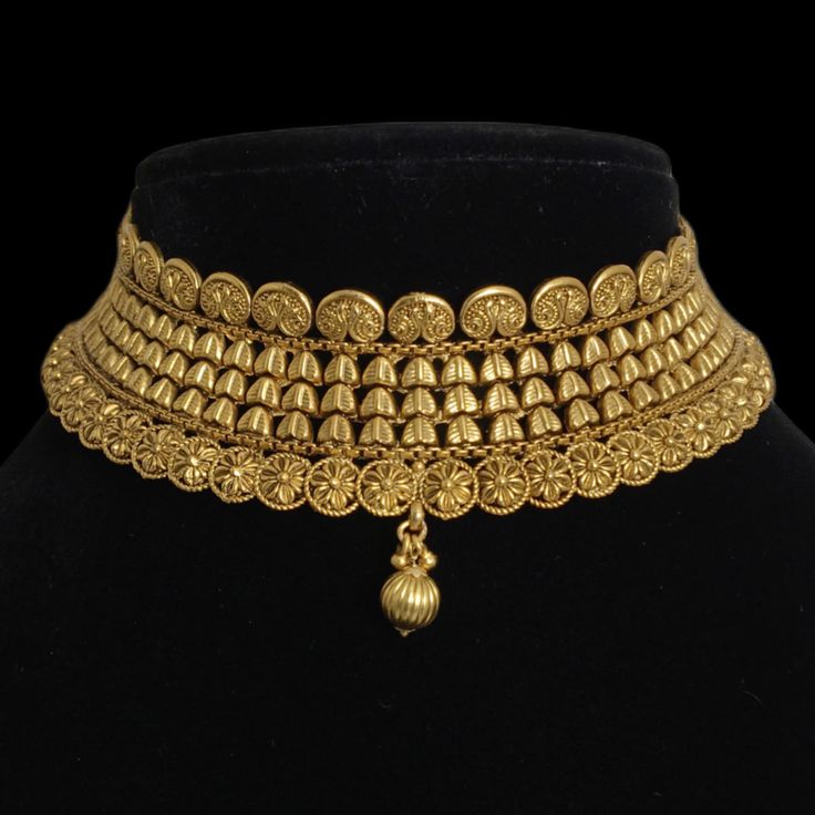 India Gold Necklace, a dazzling piece of Temple Jewelry. This Choker Necklace exudes timeless elegance and is ideal for weddings and special occasions. Crafted in the South Indian tradition, it reflects the rich heritage of Temple Jewelry. Adorn yourself with the intricate designs of this Temple Necklace Set, perfect for making a statement. Whether it's a wedding or a grand celebration, this piece adds a touch of sophistication to your ensemble. *𝐏𝐑𝐎𝐃𝐔𝐂𝐓 𝐃𝐄𝐓𝐀𝐈𝐋* * Material: Brass * Wedding Jewelry Sets With Filigree, Wedding Filigree Jewelry Sets, Gold Necklaces With Elegant Design For Anniversary, Traditional Gold Necklaces For Wedding, Traditional Gold Necklace For Wedding, Ornate Choker Necklace With Intricate Design, Classic Gold Jewelry Sets For Celebration, Traditional Gold Wedding Necklace, Ornate Choker Necklace For Wedding