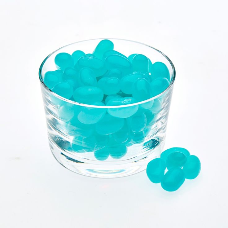 a glass bowl filled with blue gummy bears