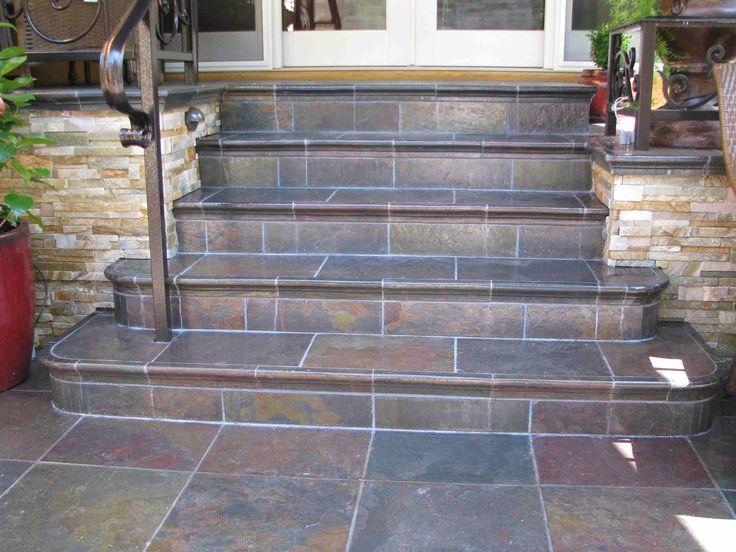 a set of stone steps leading up to a front door