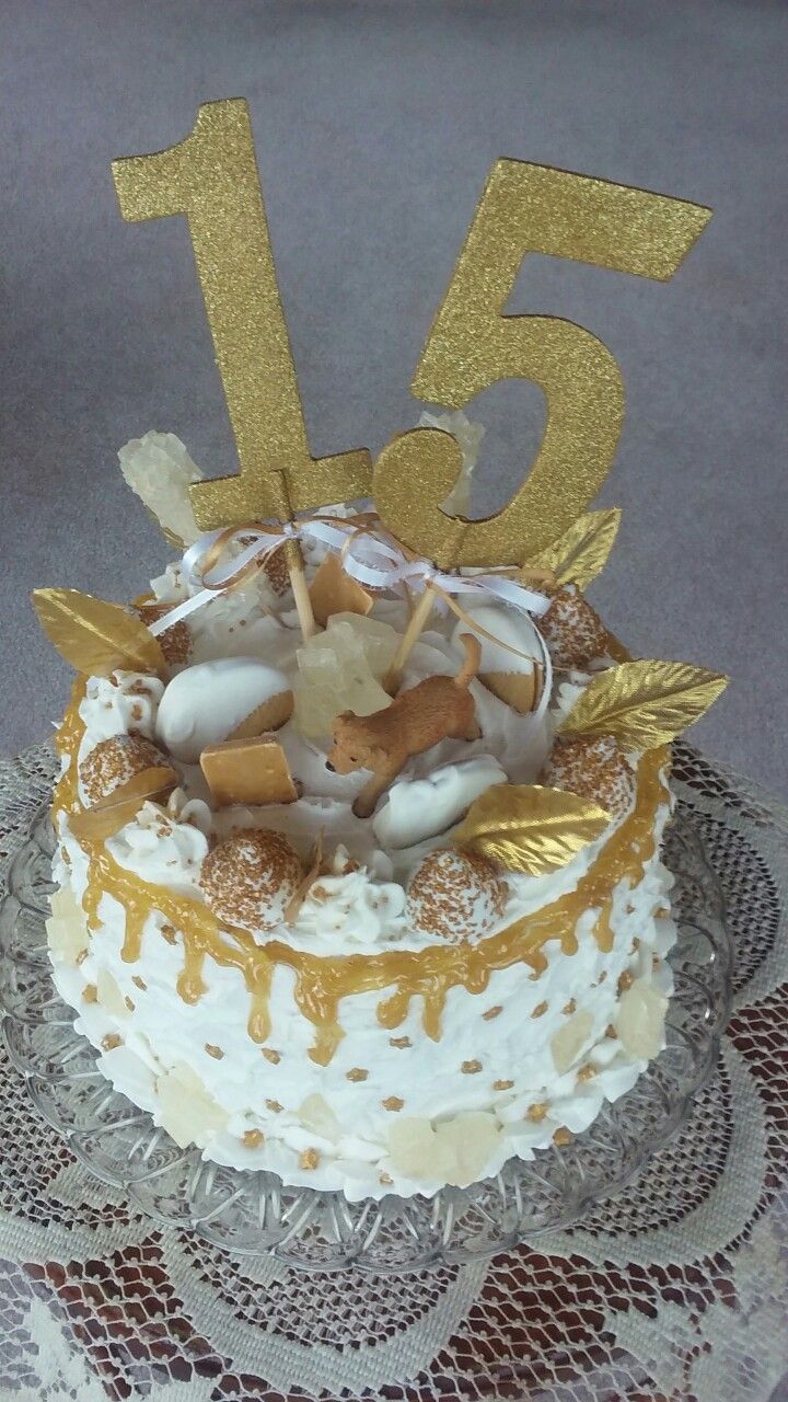 there is a cake that has the number fifteen on it with gold decorations and frosting