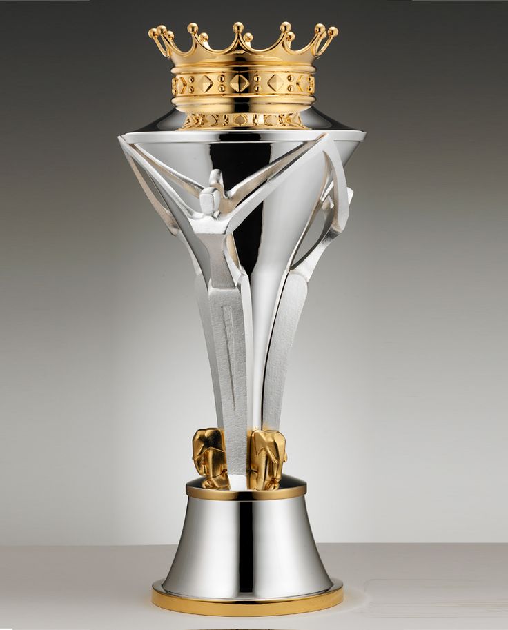 a silver and gold trophy with a crown on top