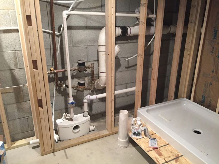 a bathroom that is under construction with pipes and piping in the wall next to it