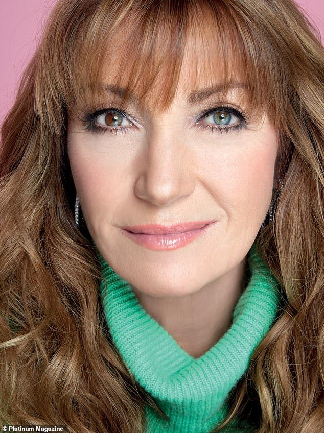 a close up of a person with long hair and wearing a green scarf around her neck