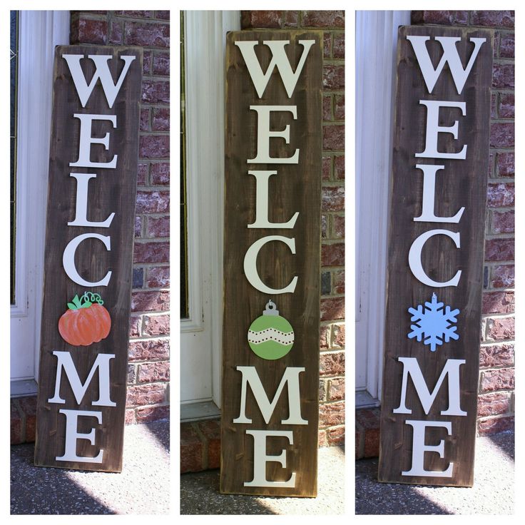 three wooden welcome signs with pumpkins and snowflakes