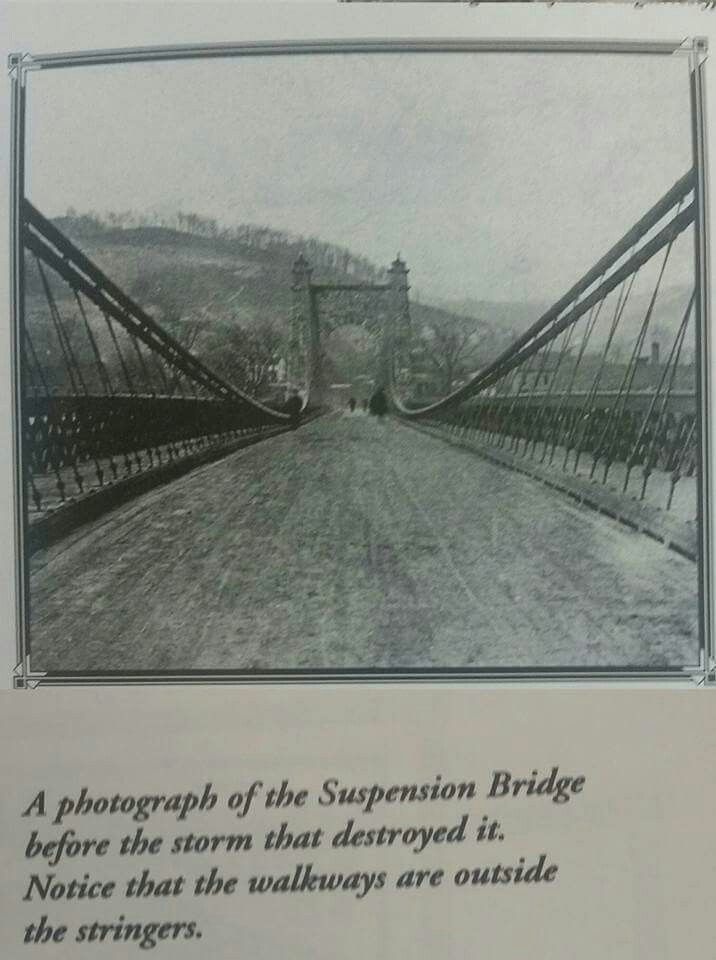 a black and white photo of a bridge with a poem on it's side