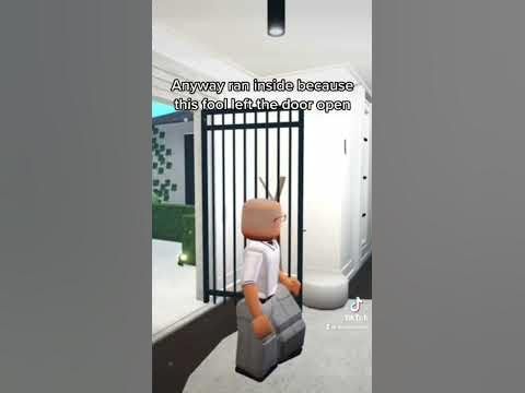 a cartoon character is standing in front of a jail cell door and holding a suitcase