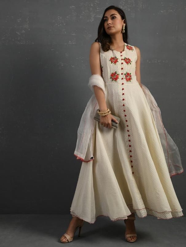 A double-layered umbrella cut front open Chanderi kurta with all-over floral buttis in yoke made using beads, sequins and silk French knots. Beadwork runs along the neckline and armhole. Contrast buttons and scalloped edges embroidered double layered flared hemline. The kurta comes with a delicate chanderi dupatta with all over sequence work and a wide woven zari border at the hem. Kurta measurements (in Inches): Size S: Bust - 38", Waist - 35", Length: 52" Size M: Bust - 40", Waist - 37", Lengt Sleeveless Chanderi Salwar Kameez For Party, Festive Sleeveless Silk Kurta, Bollywood Style Sleeveless Embellished Anarkali Set, Semi-stitched Sleeveless Anarkali Set With Mirror Work, Designer Sleeveless Raw Silk Kurta, Traditional Sleeveless Embellished Anarkali Set, Semi-stitched Sleeveless Kurta With Mirror Work, Sleeveless Salwar Kameez With Resham Embroidery, Designer Sleeveless Kurta With Mirror Work