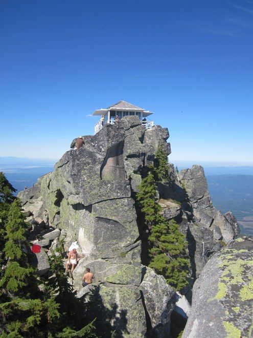 people are standing on the top of a mountain