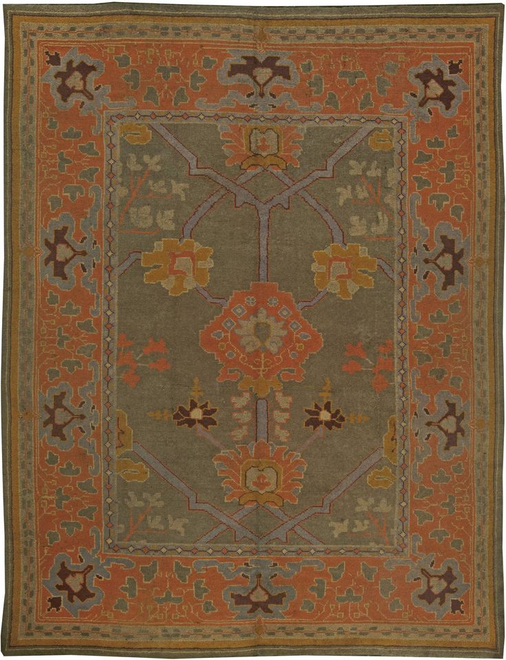 an antique rug with many different colors and designs on the border, including oranges, browns