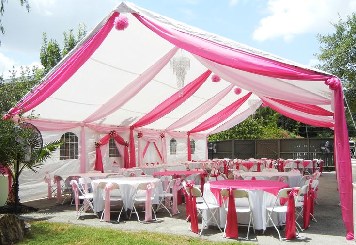 a pink and white tent set up for a party