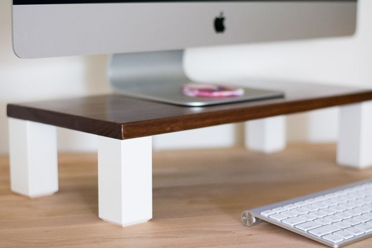 an apple computer sitting on top of a wooden desk next to a keyboard and mouse