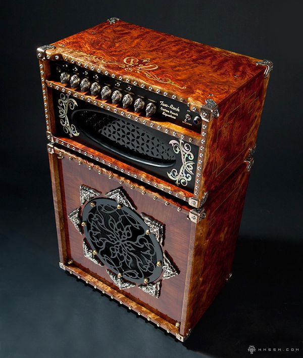 an old fashioned radio sitting on top of a wooden box with intricate carvings and designs