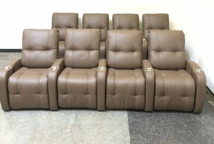 a row of brown recliner chairs sitting next to each other on top of a floor