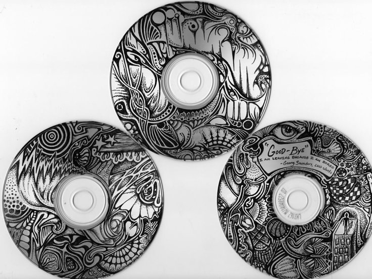 three black and white plates with designs on them