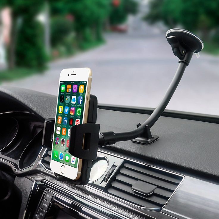 an iphone is attached to the dashboard of a car