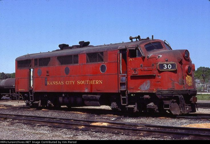 an old red train is sitting on the tracks