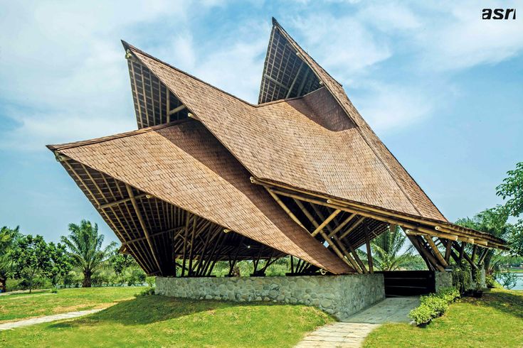 the building is made out of bamboo and has two large triangular shaped windows on each side