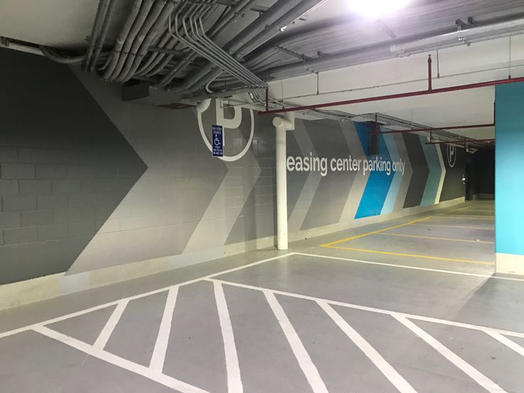 an empty parking garage with blue and white painted walls