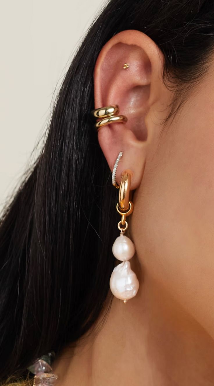 Martha Calvo's stunning Baroque pearl earrings is where nature's beauty meets craftsmanship. Each pearl, shaped by the sea's whims, is a unique creation, celebrated in purposefully mismatched designs plated in luxurious gold. These earrings offer versatility with removable pearls, transforming them into classic hoop earrings. They gracefully adorn the ears with a secure post fastening for pierced ears. Embrace the elegance of Martha Calvo's Baroque pearl earrings, perfect for any occasion, wheth Luxury Sustainable, Basket Tote, Baroque Pearl Earrings, Wedding 2024, Linda Farrow, Baroque Pearls, Nature's Beauty, Pierced Ears, Jewelry Bags