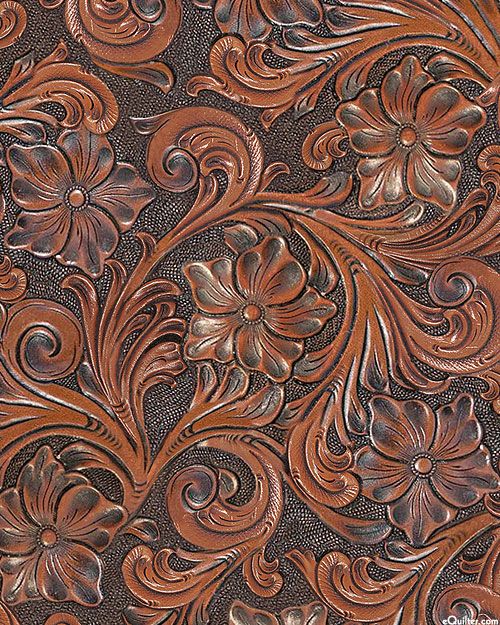 an intricately carved leather background with flowers and leaves