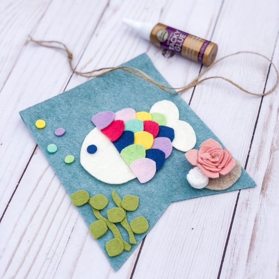 a craft project with felt fish and flowers