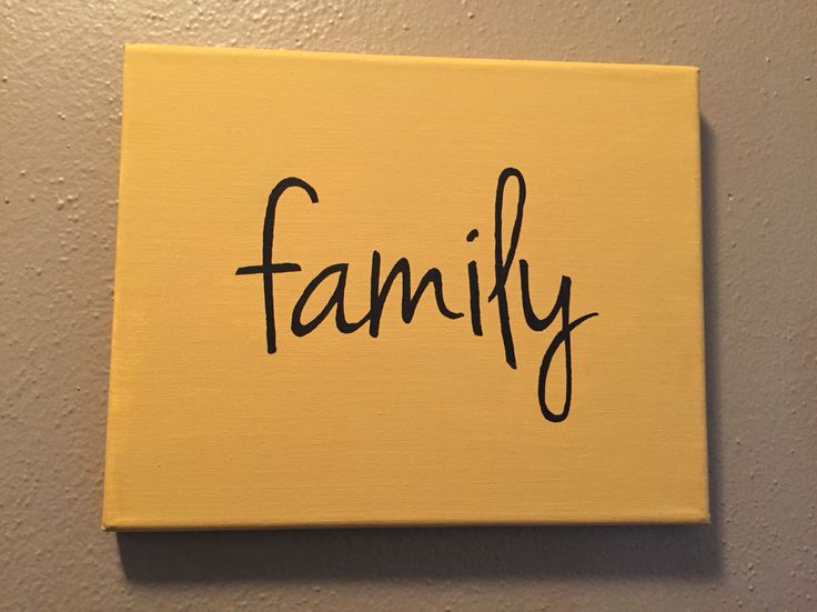 a yellow sign with the word family written in cursive black ink on it