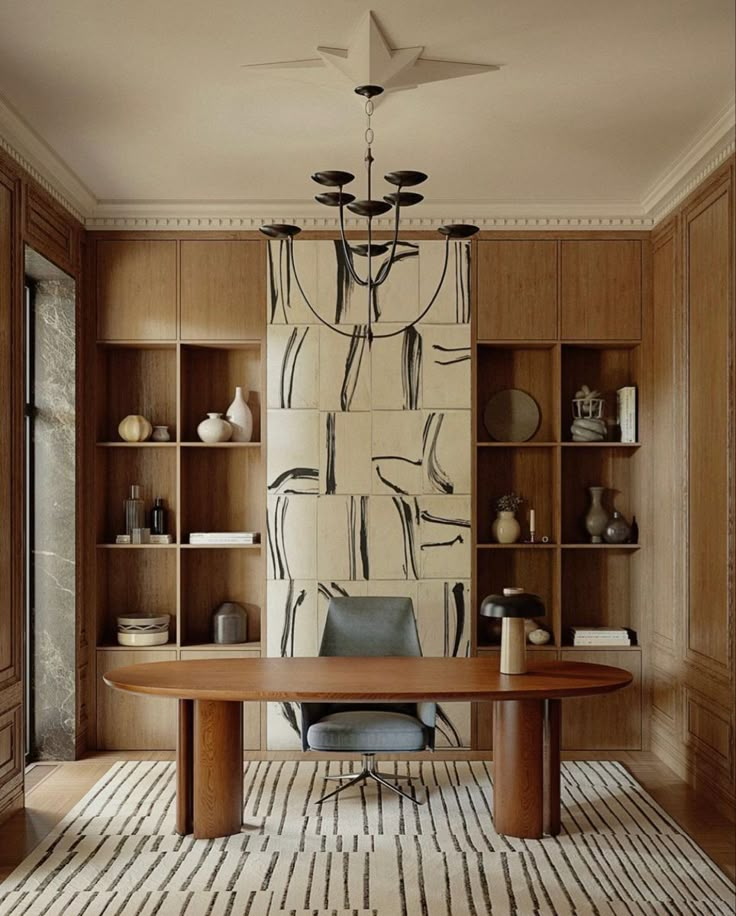 a room with a table, chairs and shelves filled with vases on the wall