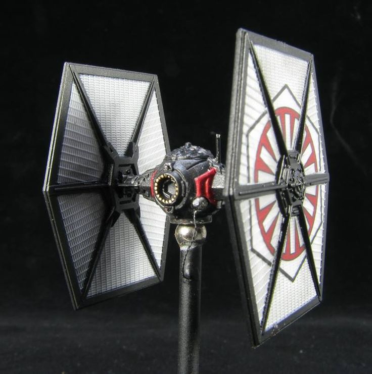 a star wars tie fighter model on a black background