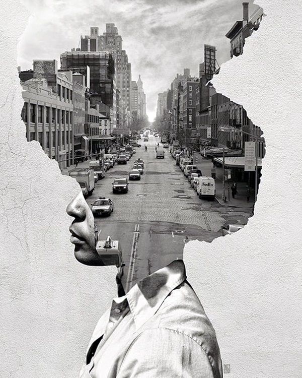 a black and white photo of a man's face in the middle of a city street