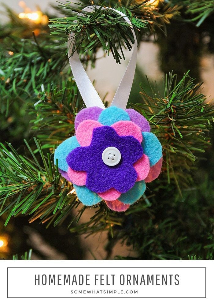 a felt flower ornament hanging on a christmas tree with the words homemade felt ornaments