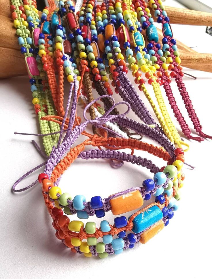 Hippie Multicolor Bracelets For Friendship, Adjustable Multicolor Hand Wrapped Friendship Bracelets, Multicolor Hand Wrapped Beaded Bracelets For Friendship, Multicolor Hand Wrapped Friendship Bracelets As Gifts, Bohemian Multicolor Hand Wrapped Braided Bracelets, Hippie Style Hand-strung Friendship Bracelet Gift, Multicolor Beaded Braided Bracelet For Festivals, Bohemian Rainbow Beaded Bracelets With Sliding Knot, Adjustable Multicolor Beaded Bracelet For Festival