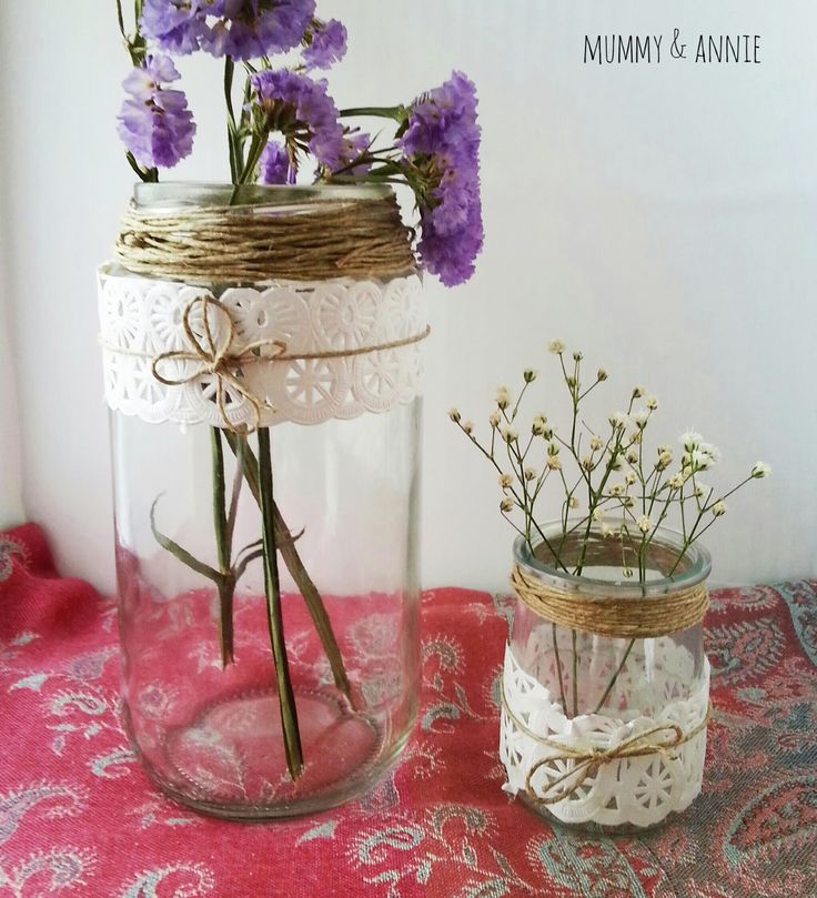 two mason jars with flowers in them on a table