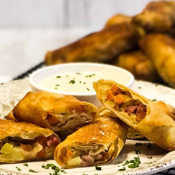 some food is sitting on a plate with dipping sauce