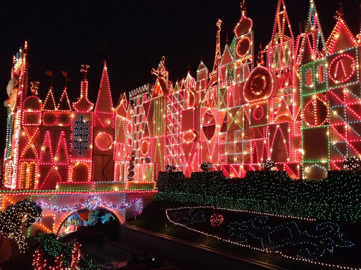 an elaborately lit castle with lots of lights on it's sides at night