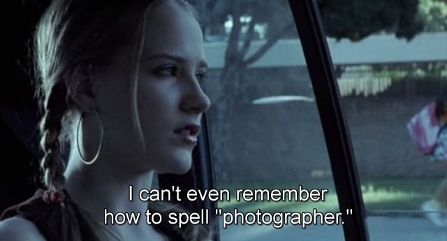 a woman sitting in the back seat of a car next to a window with a quote written on it