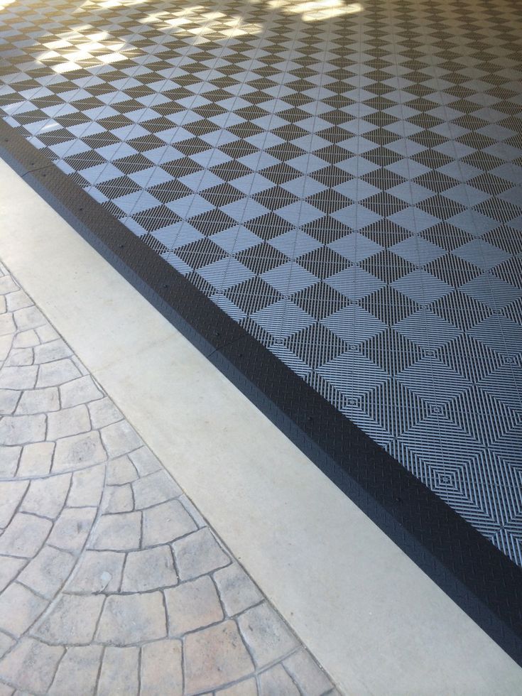 a black and white checkered floor next to a brick walkway