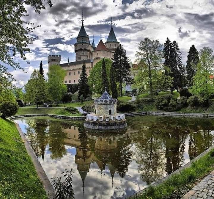 an old castle is reflected in the water