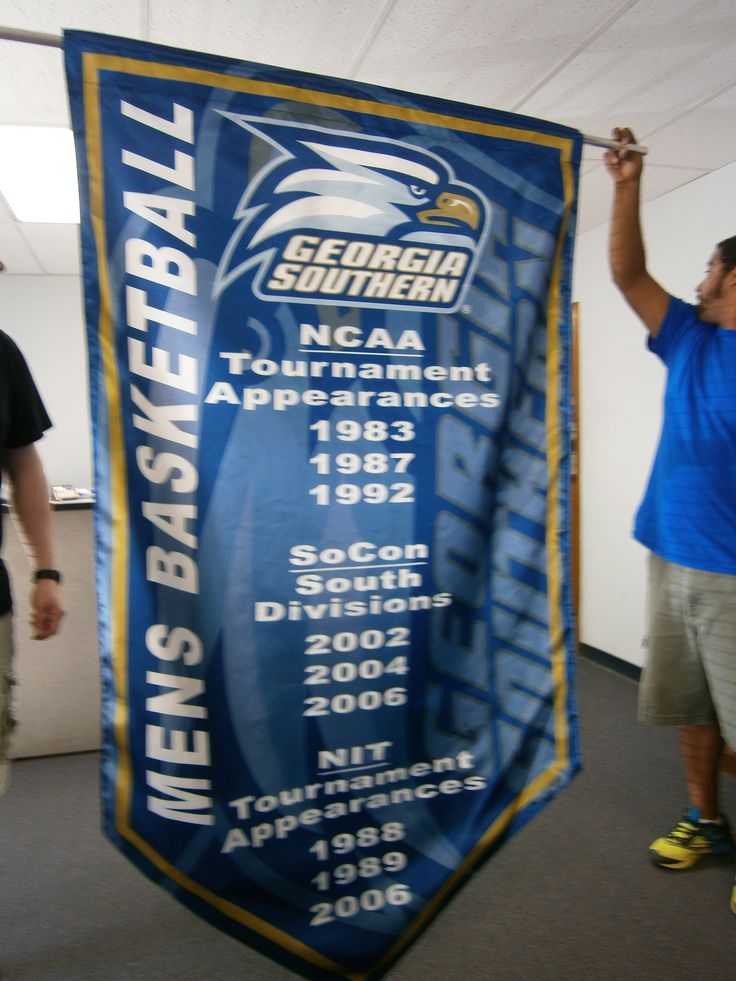 a man holding up a banner in an office